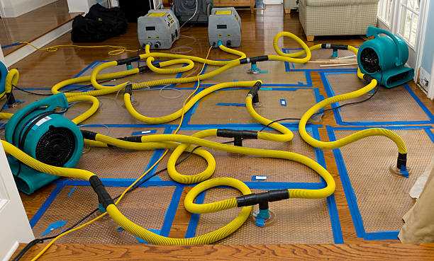 Professional Flood Damage Restoration technician working in Durham, ME